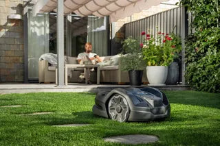 Husqvarna Automower 305E NERA mowing a garden