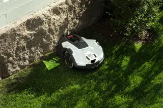 Husqvarna Automower 410VE NERA mowing beside a wall